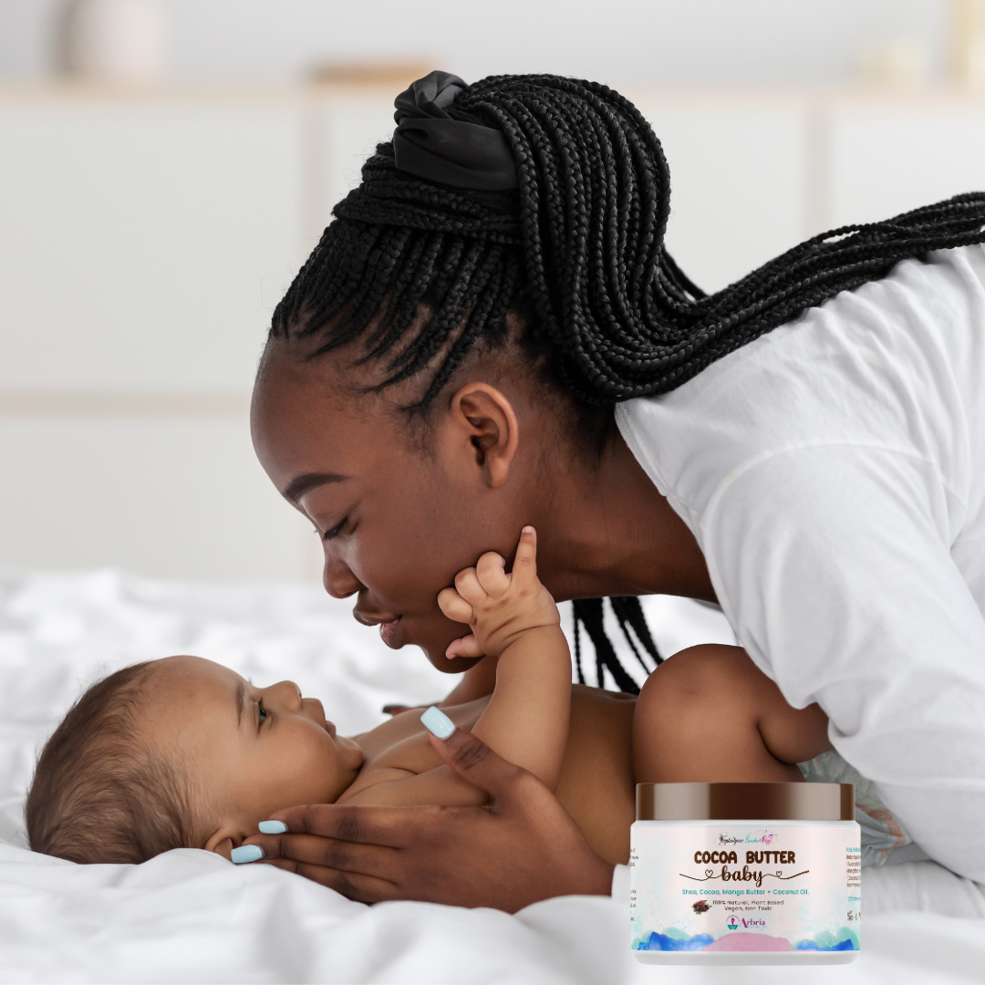 Mother applying fragrance-free cocoa butter moisturizer on baby's skin