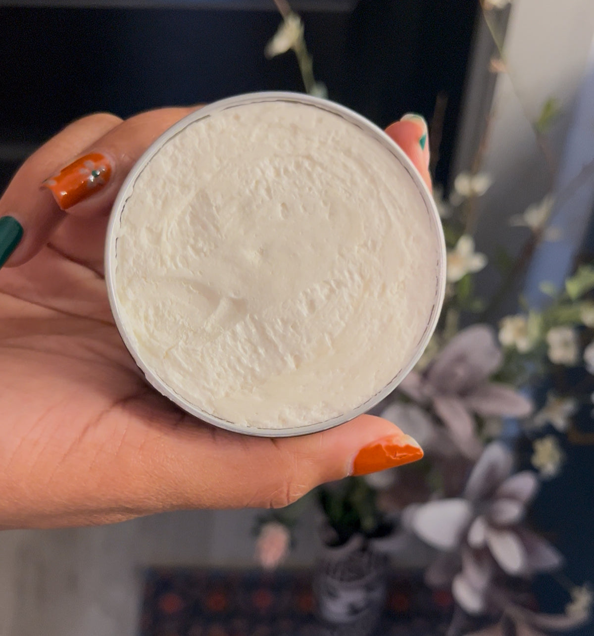 Close-up of Arbria Creations whipped body butter showing its rich, fluffy, creamy texture in an open jar