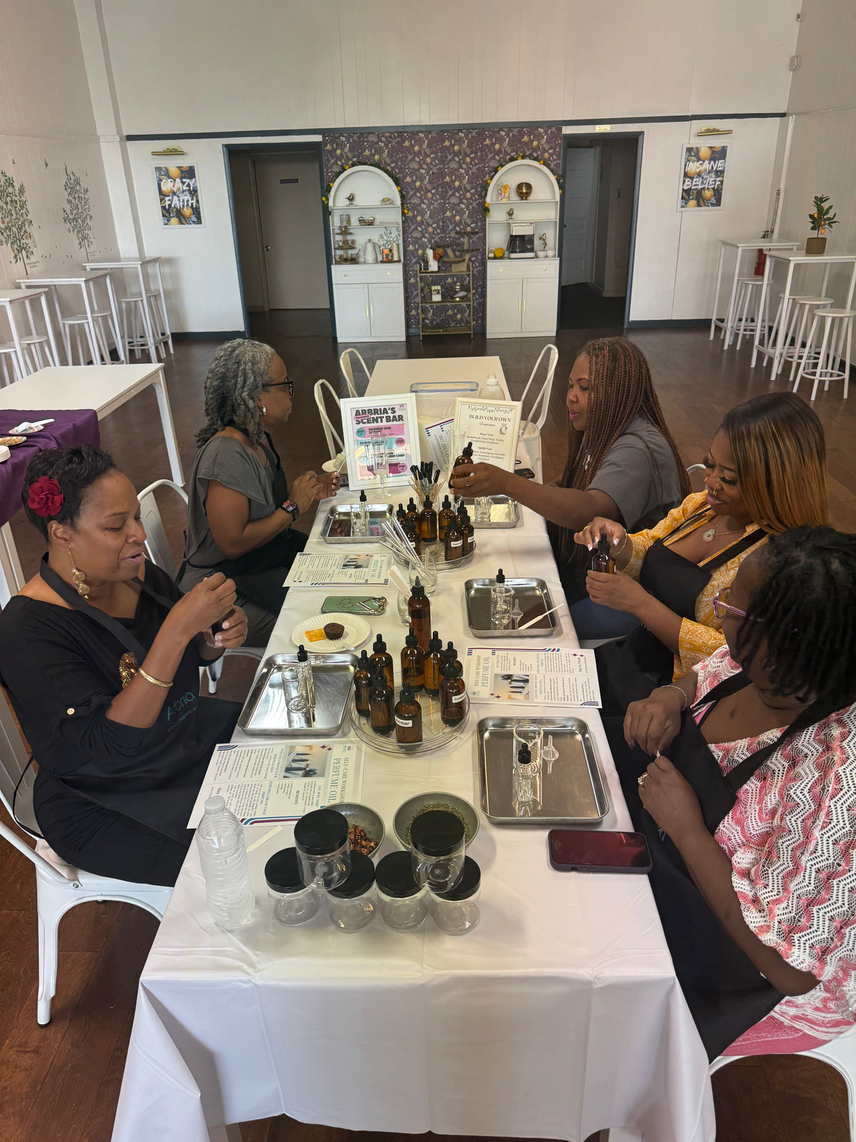 Women creating DIY body care products at a self-care workshop